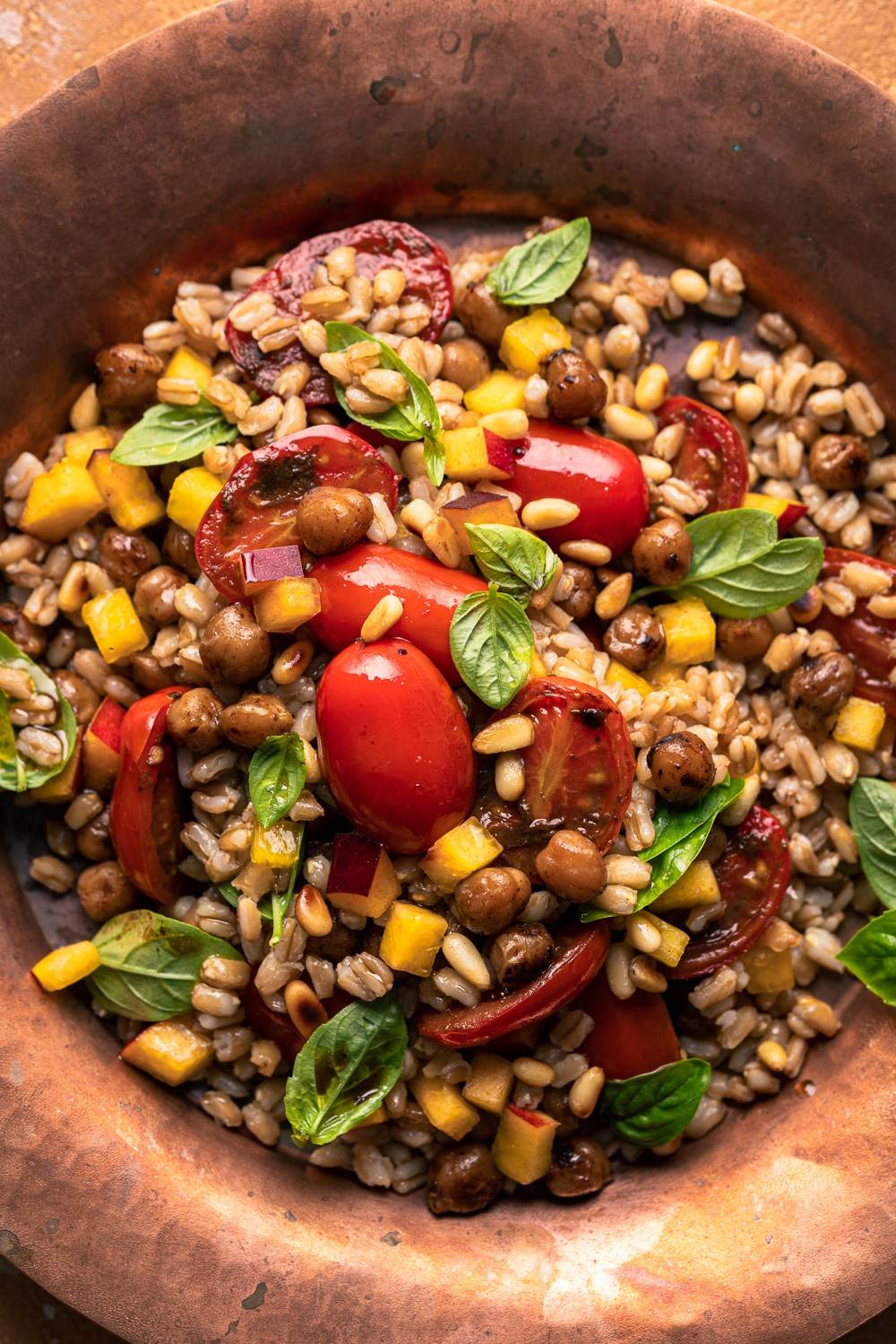 insalata di farro vegana con pomodori aglio nero pesca